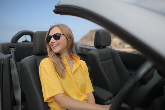 Women in Yellow Shirt and Sunglasses Sitting in Car