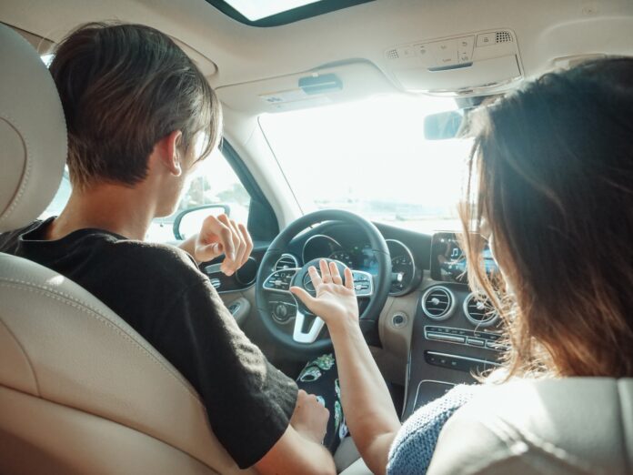 Man and Women in The Front of a Vehicle